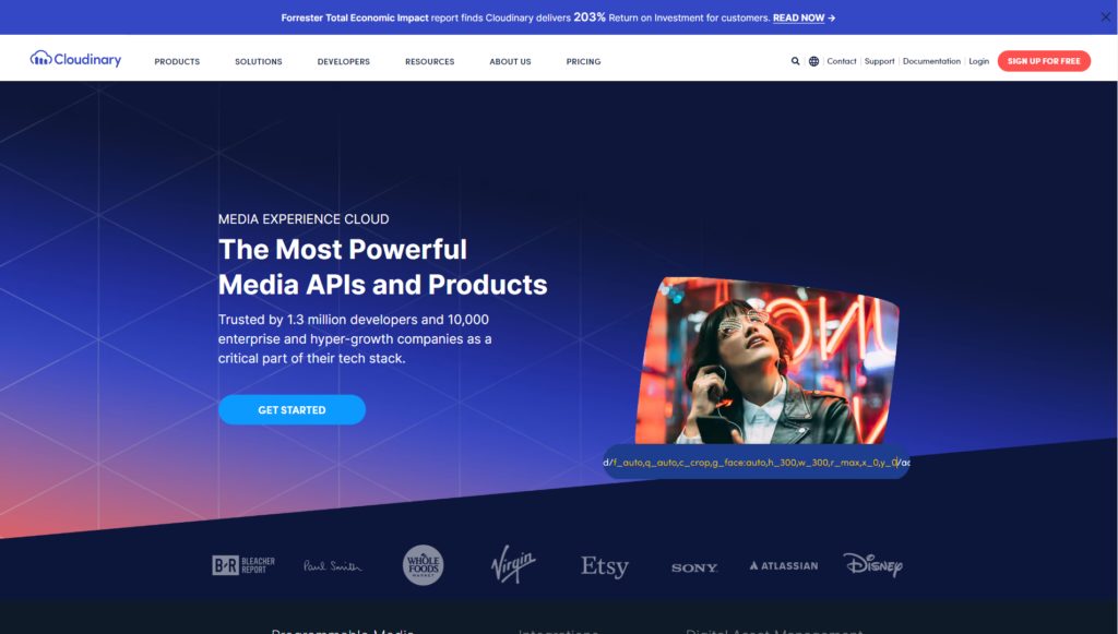 Cloudinary homepage promoting powerful media APIs and products, featuring a bold headline, call-to-action button, and logos of brands like Virgin and Disney.